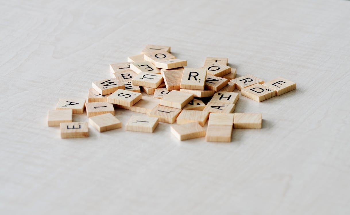 Scrabble pieces laying in a pile.