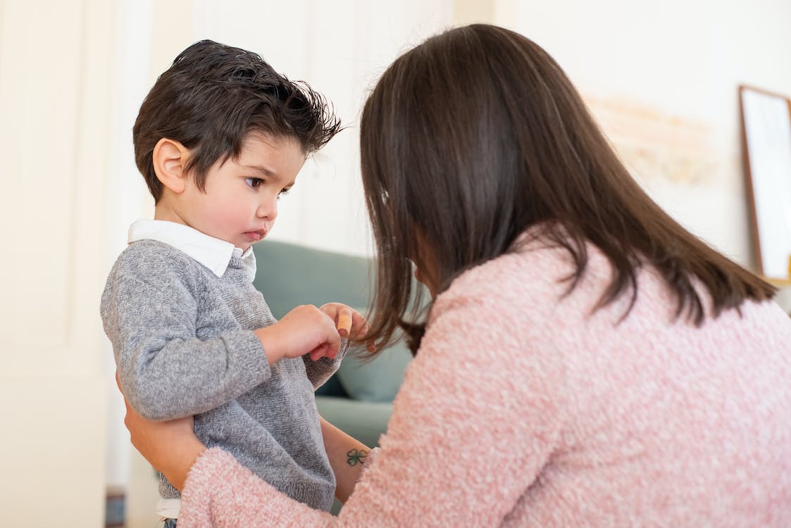 A parent talking to her young child.