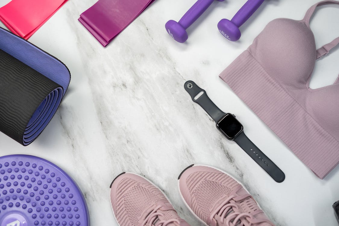 Trainers and other exercise equipment laying on the floor.