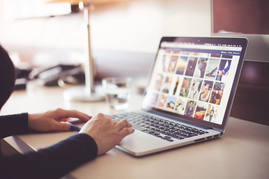 A person browsing pictures on an open laptop.