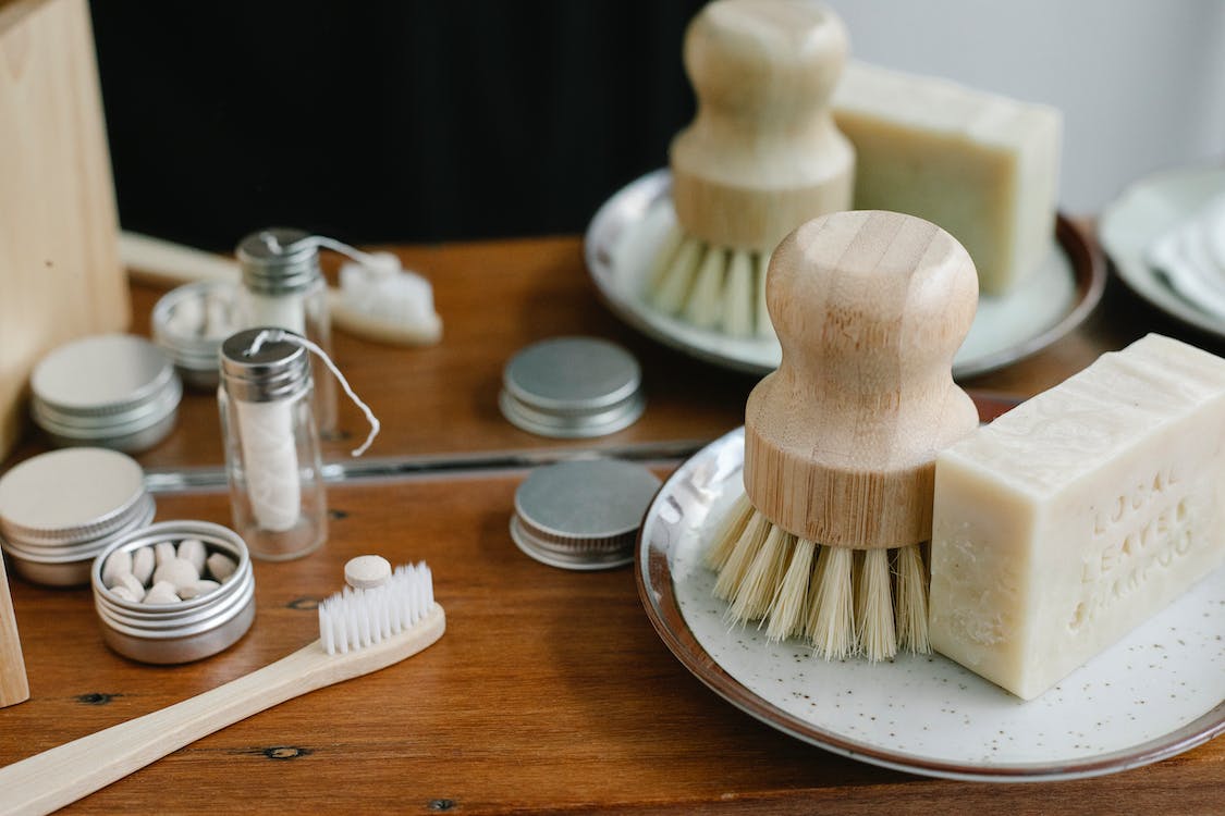 A shelf containing a toothbrush and other bathroom items.