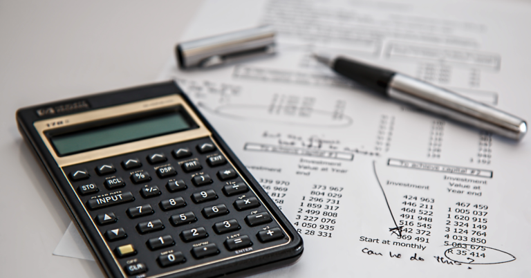 Company accounts with a calculator and pen sitting on top.