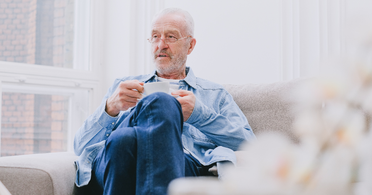 An older gentleman drinking tea.